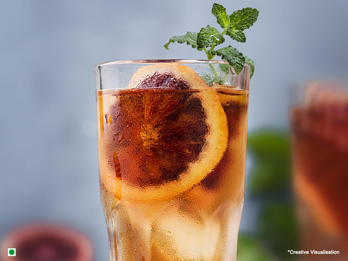 An image of chilled ice tea in a glass filled with ice cubes and slices of orange! 