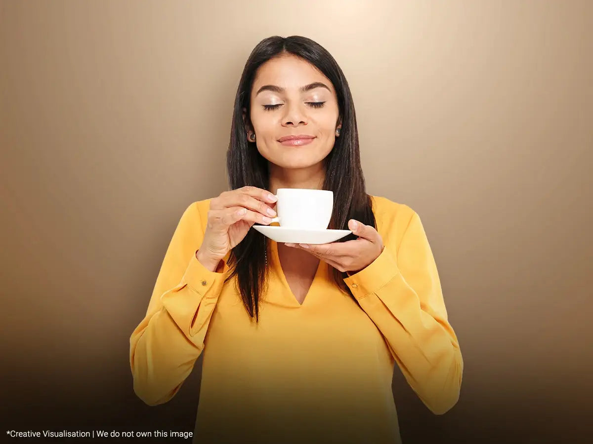 A girl smiling while drinking tea 