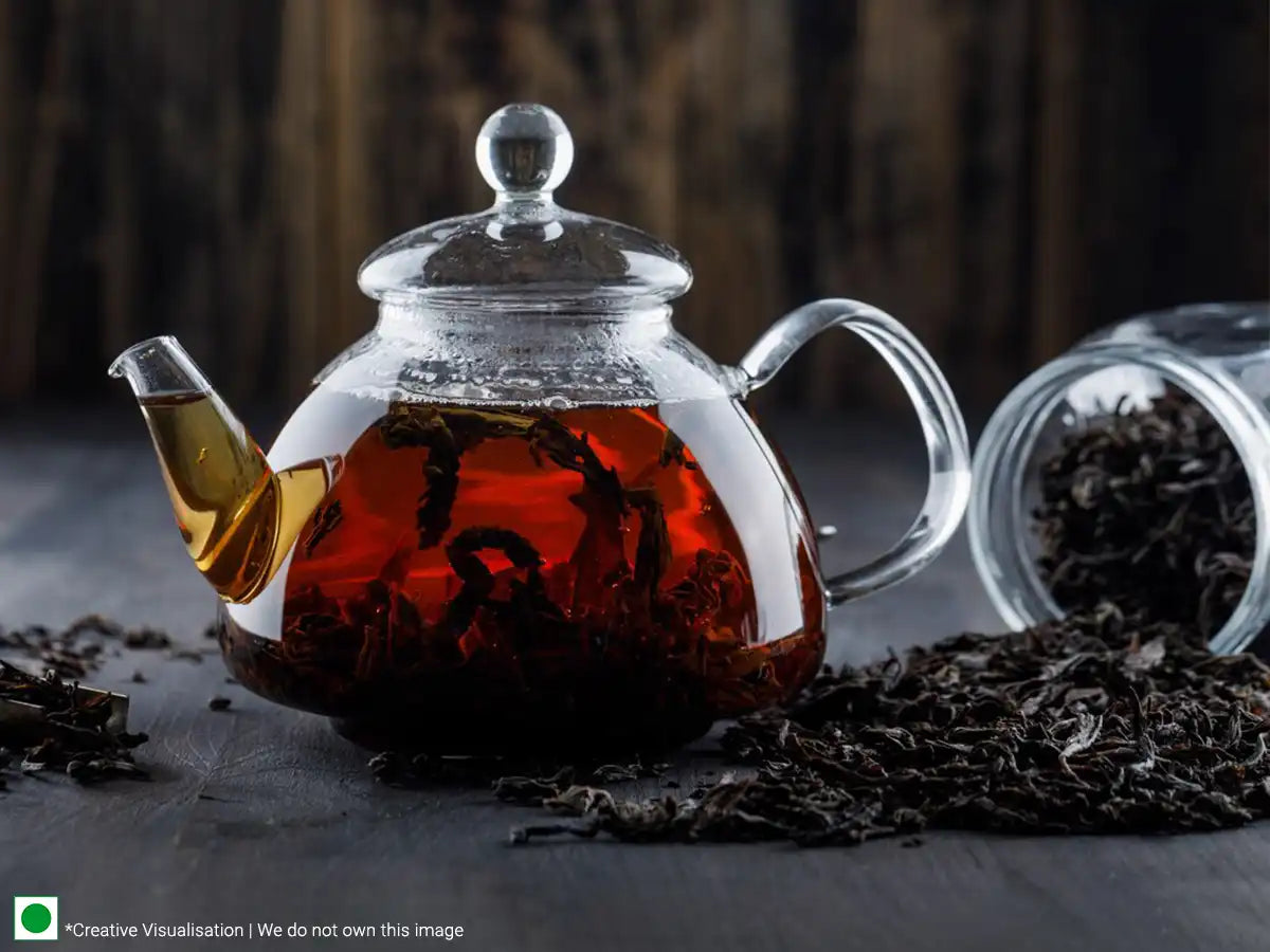 A cup of tea and black tea leaves