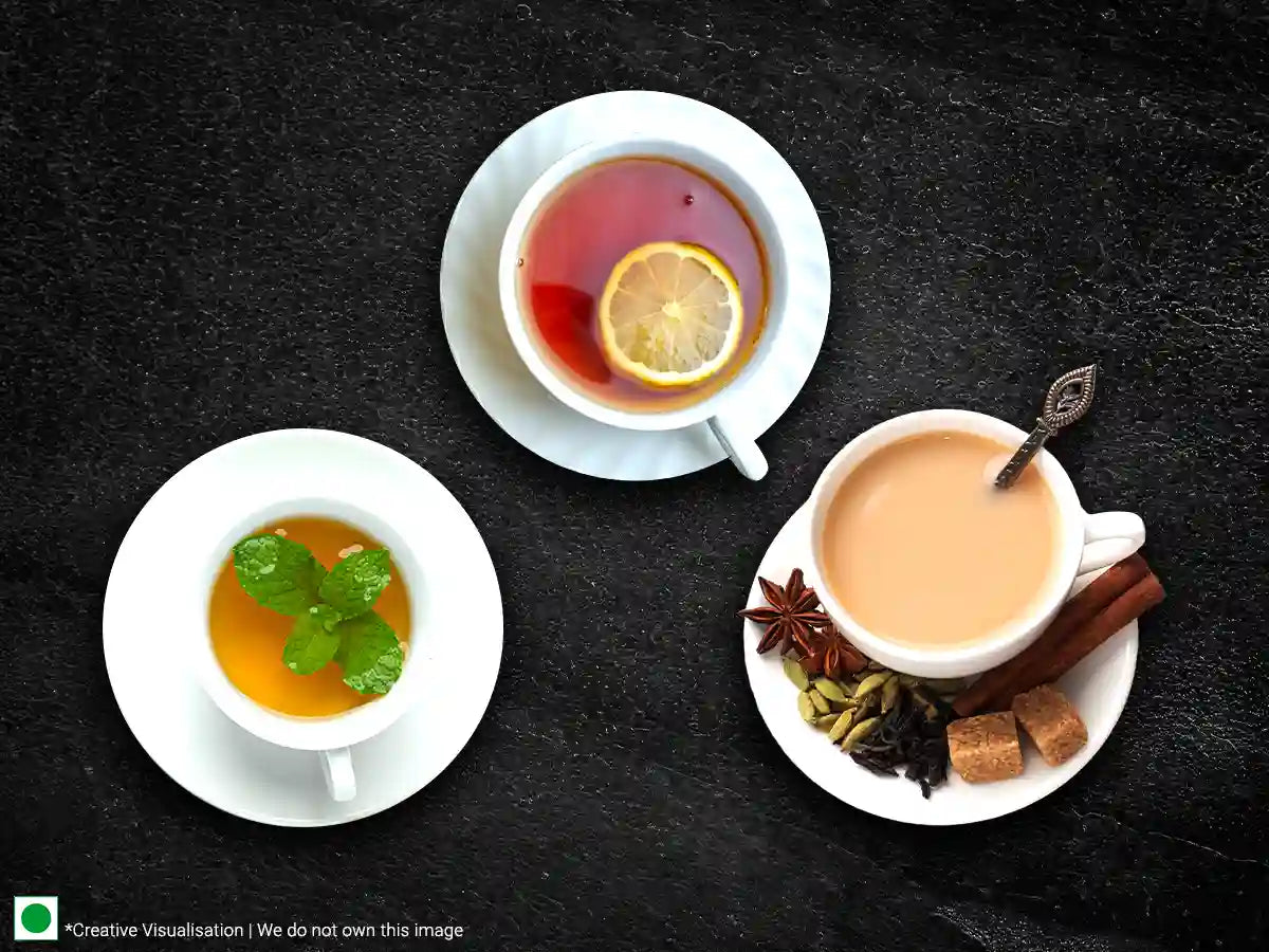 Three cups of tea with lemon, cinnamon, and spices, served in delicate cups